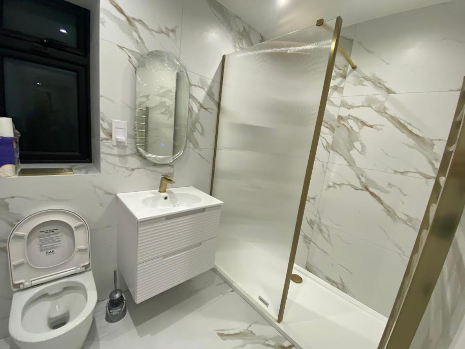 Modern marble bathroom with gold fixtures
