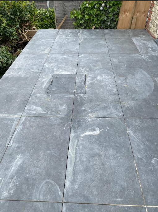 Garden patio with slate tiling and landscaping