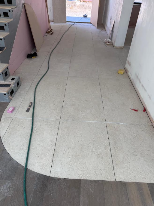 Floor tiling installation in progress