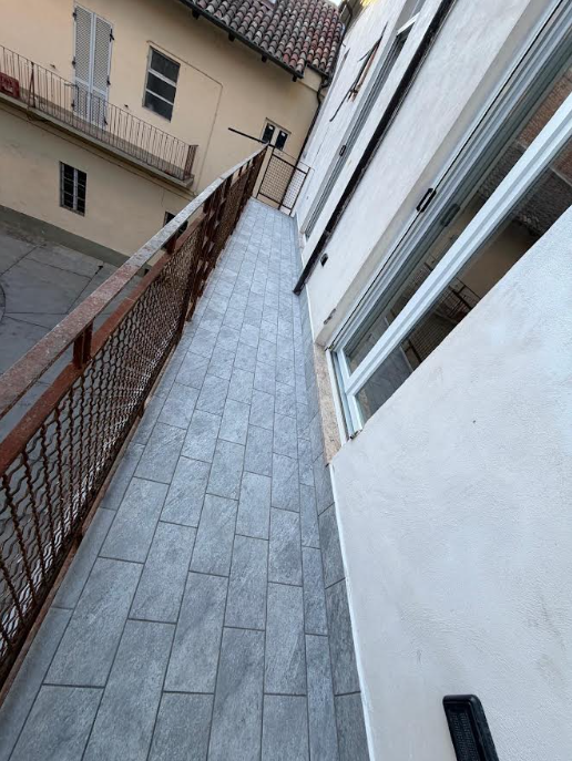 Narrow courtyard pathway with large format tiling